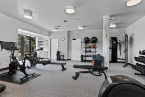 a gym with treadmills and cardio equipment in a room at Hotel De Novo Springdale, Tapestry Collection by Hilton in Springdale