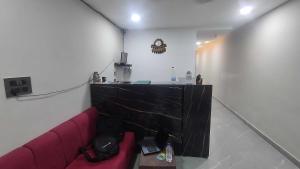 a living room with a red couch and a table at HOTEL O SKY in Phundardih +17 photos