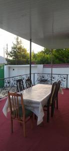 a table with chairs and an umbrella on a roof at Gabala,yard, house in Gabala +5 photos