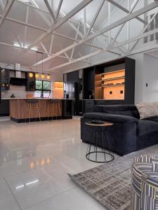 a living room with a couch and a kitchen at Euphoria 447 in Naboomspruit +99 photos