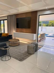 a living room with a tv on a wall at Euphoria 447 in Naboomspruit