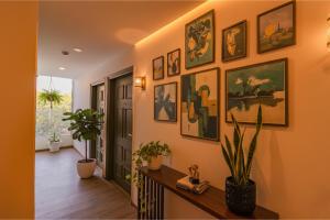 a hallway with a bunch of paintings on the wall at FabHotel Hargobind Enclave in New Delhi