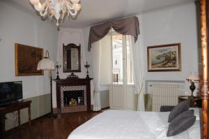 a bedroom with a bed and a fireplace and a chandelier at A Casa di Teresa in Trecchina