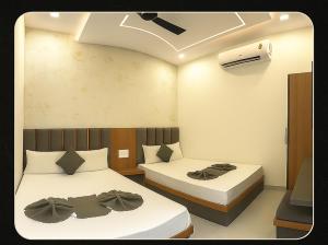 a bedroom with two beds and a ceiling fan at Gray Stone- Two mints by walk From Golden Temple in Amritsar