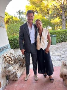 a man and a woman standing next to a fireplace at Villa Anna GuestHouse in Brindisi