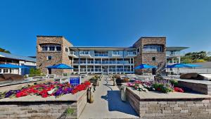 a large building with flowers in front of it at Put-in-Bay Waterfront Condo #107 in Put-in-Bay