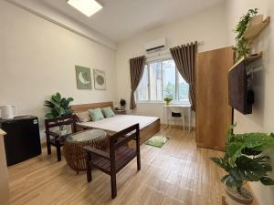 a living room with a couch and a table at Central room in district 1, 450m to Ben Thanh market in Kon Rung (1)
