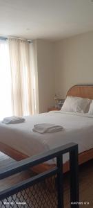 a large bed in a bedroom with a window at SecondHomeBali in Canggu