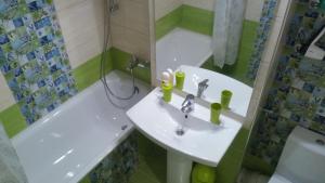 a bathroom with a sink and a toilet and a tub at Universitate Residence in Bucharest