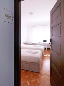 two beds in a room with a door open at Uporto House Villa in Porto