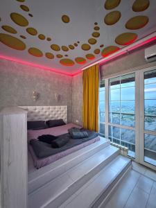 a bedroom with a large bed with a red ceiling at Уютная квартира in Almaty