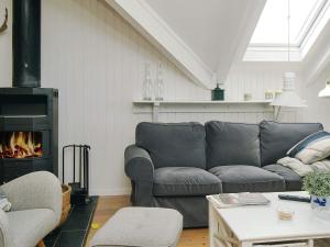 a living room with a couch and a fireplace at 4 star holiday home in Asnæs in Asnæs +19 photos