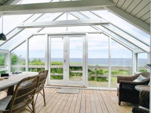 a conservatory with a glass roof with a table and chairs at 4 star holiday home in Asnæs in Asnæs