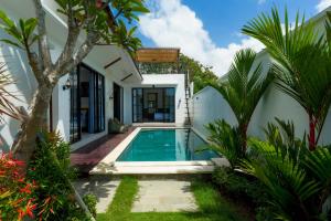 a pool in the backyard of a villa at Anjoe Villa New Modern 2BR Villa with Private Pool & Rooftop in Ungasan