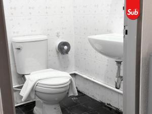 a bathroom with a white toilet and a sink at Happy One-Bedroom Stay in Hat Yai in Ban Thung Ngai