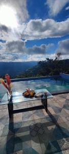 a table sitting on top of a swimming pool at Koko House in Panchgani