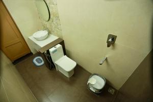 a small bathroom with a toilet and a sink at Estella Marari Beach Villa in Mararikulam