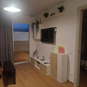a living room with a tv on the wall at Lucas beach in Mogán