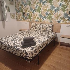 a bed with towels on it in a room at Lucas beach in Mogán
