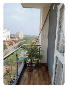 a balcony of a building with two plants on it at HarshYog Homestay in Nashik
