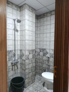 a bathroom with a shower with a toilet and a sink at Luxe 1 Bedroom Apartment in Doha emporium B-17, Margalla views in Islamabad