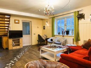 a living room with a couch and a table at Lake View Apartment at North Lakeside Villa Plateliai in Medsėdžių