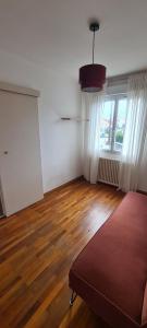 an empty room with a bed and a large window at Maison proche centre ville Nantes in Saint-Herblain