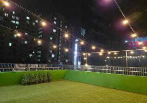 a balcony at night with lights on a building at 라메르스테이&수원파티루프탑 in Suwon