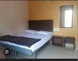 Ένα ή περισσότερα κρεβάτια σε δωμάτιο στο Aryadurga Lodge