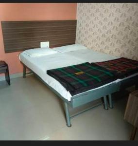 Ένα ή περισσότερα κρεβάτια σε δωμάτιο στο Aryadurga Lodge