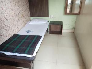 Ένα ή περισσότερα κρεβάτια σε δωμάτιο στο Aryadurga Lodge