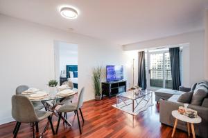 a living room with a table and a couch at Elegant 2BR 2BA Condo Heart of Mississauga SQ1 in Mississauga
