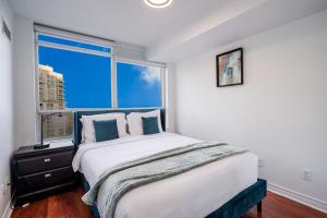 a bedroom with a large bed and a large window at Elegant 2BR 2BA Condo Heart of Mississauga SQ1 in Mississauga +39 photos