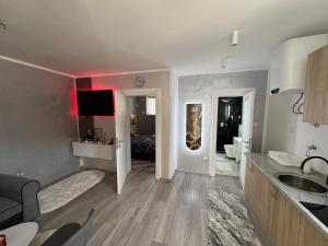 a room with a kitchen and a living room at Apartman Đak in Foča