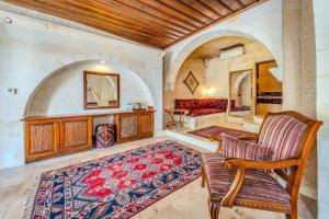a living room with a couch and a rug at MDC Cave Hotel Cappadocia in Ürgüp +47 photos