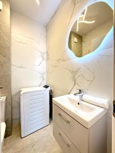 a bathroom with a sink and a mirror at FeWo No 407 Lebada Lake in Pantelimon +21 photos