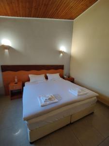 a bedroom with a white bed with two lamps on it at Dream Forest Hotel in Yerevan +71 photos