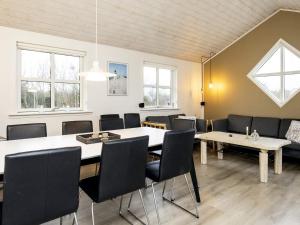 a meeting room with tables and chairs and windows at 8 person holiday home in Hirtshals-By Traum in Hirtshals