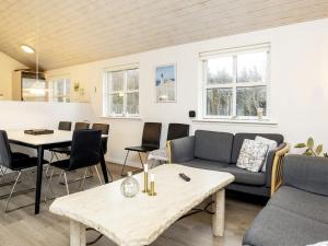 a living room with a couch and a table at 8 person holiday home in Hirtshals-By Traum in Hirtshals