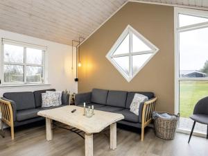 a living room with a couch and a table at 8 person holiday home in Hirtshals-By Traum in Hirtshals