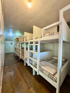 a room with four bunk beds in a room at Rustic Bed & Breakfast in Ranau