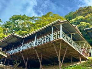 a large wooden building with a balcony at Rustic Bed & Breakfast in Ranau