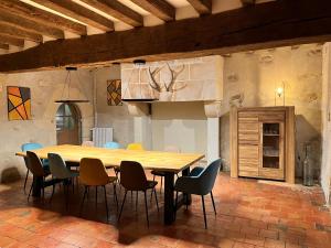 a wooden table and chairs in a room at Seigneurie du Bois Moreau in Durtal