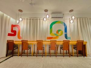 a conference room with a wooden table and chairs at HOSHTEL99 - LUX - Stay, Cowork and Cafe - Luxurious Twin Bungalow in Pune