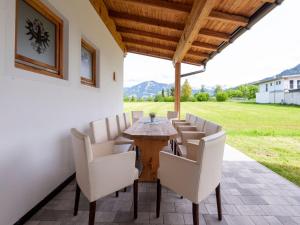 a table and chairs on a patio with a view at Holiday Home Brixen Valley Ski Bus Access in Hopfgarten im Brixental