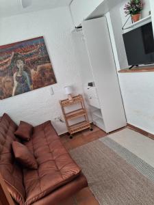 a living room with a couch and a tv at Oceanview House Altea Hills in Altea la Vieja