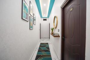 a hallway with a door and a rug on the floor at Via Awadh Royal in Ayodhya +13 photos