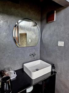 a bathroom with a white sink and a mirror at Mount Lux Villa in Devāla