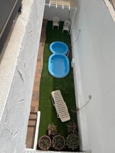 an overhead view of a patio with two blue tables and chairs at Apartamento con jardín y pequeña piscina privada para refrescarse in Maspalomas