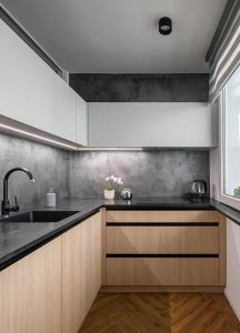 a kitchen with wooden cabinets and a sink at Pokoj Harmonie 